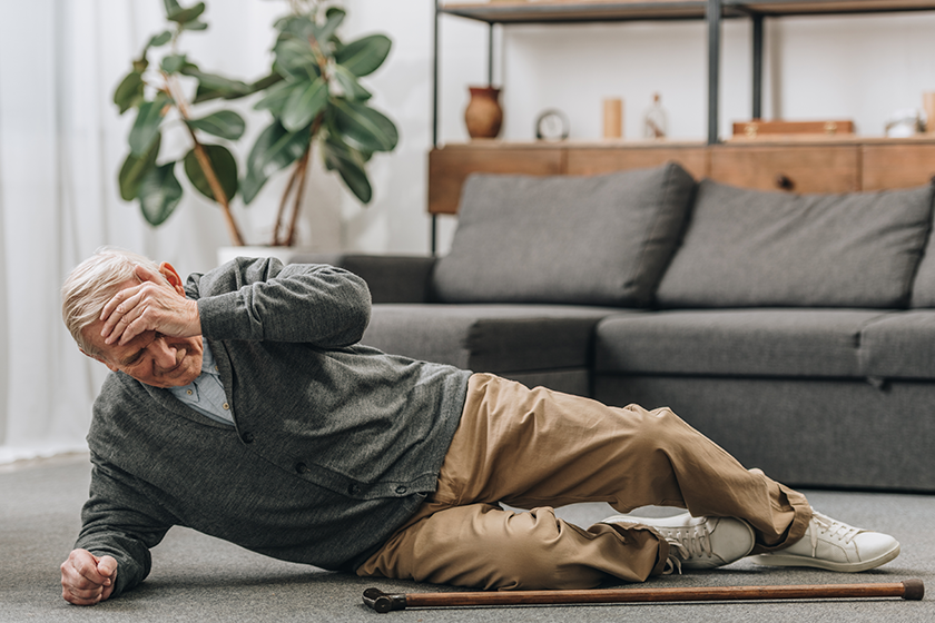 Old men falled down on floor and touching forehead 